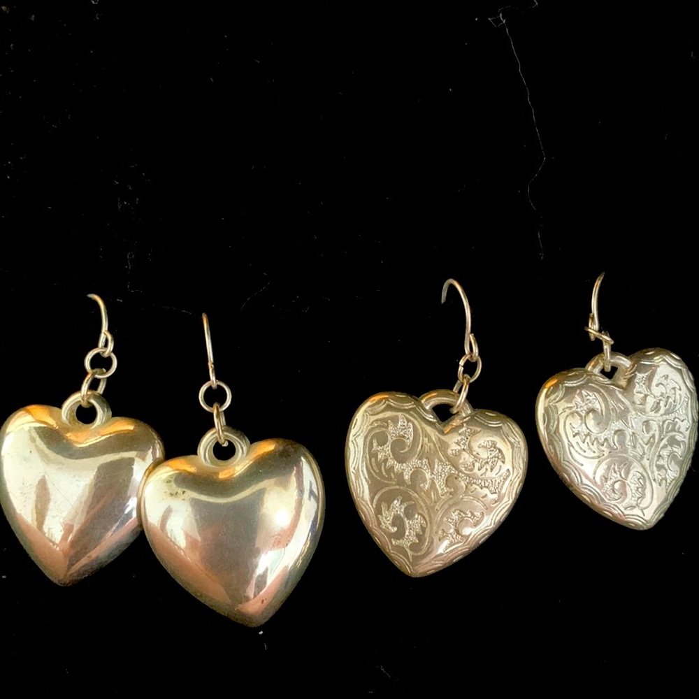 Two pairs of heart earrings.